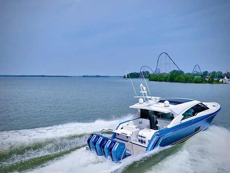 Slide: The Image of 2023 Formula 500 Super Sport Crossover cruising on a lake near a roller coaster. - 8