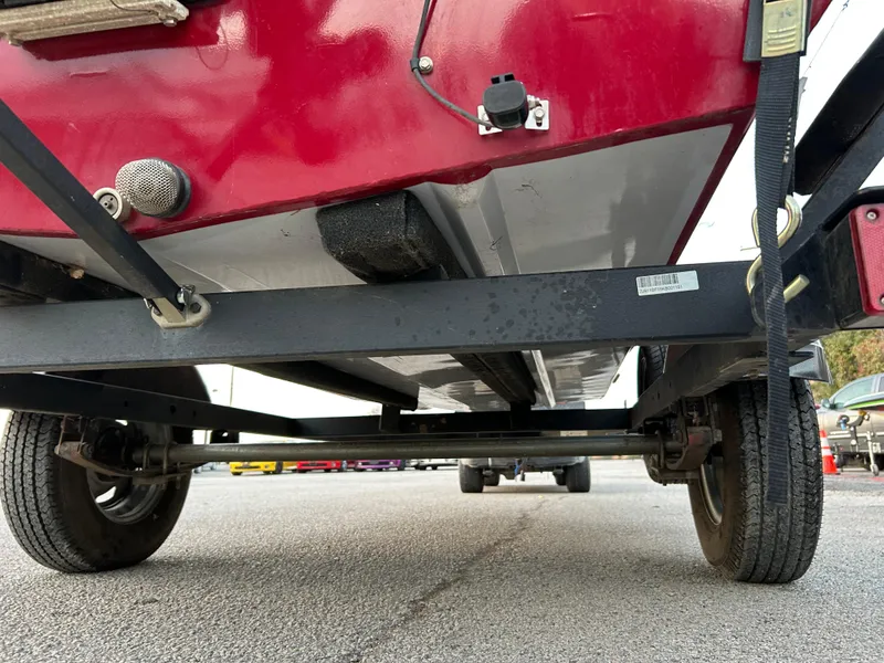 Slide: The Image of 2019 Tracker Pro 160 boat on trailer, underside view, red and black color scheme. - 15