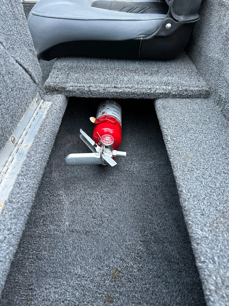 Slide: The Image of 2019 Tracker Pro 160 boat interior with fire extinguisher under seat. - 24