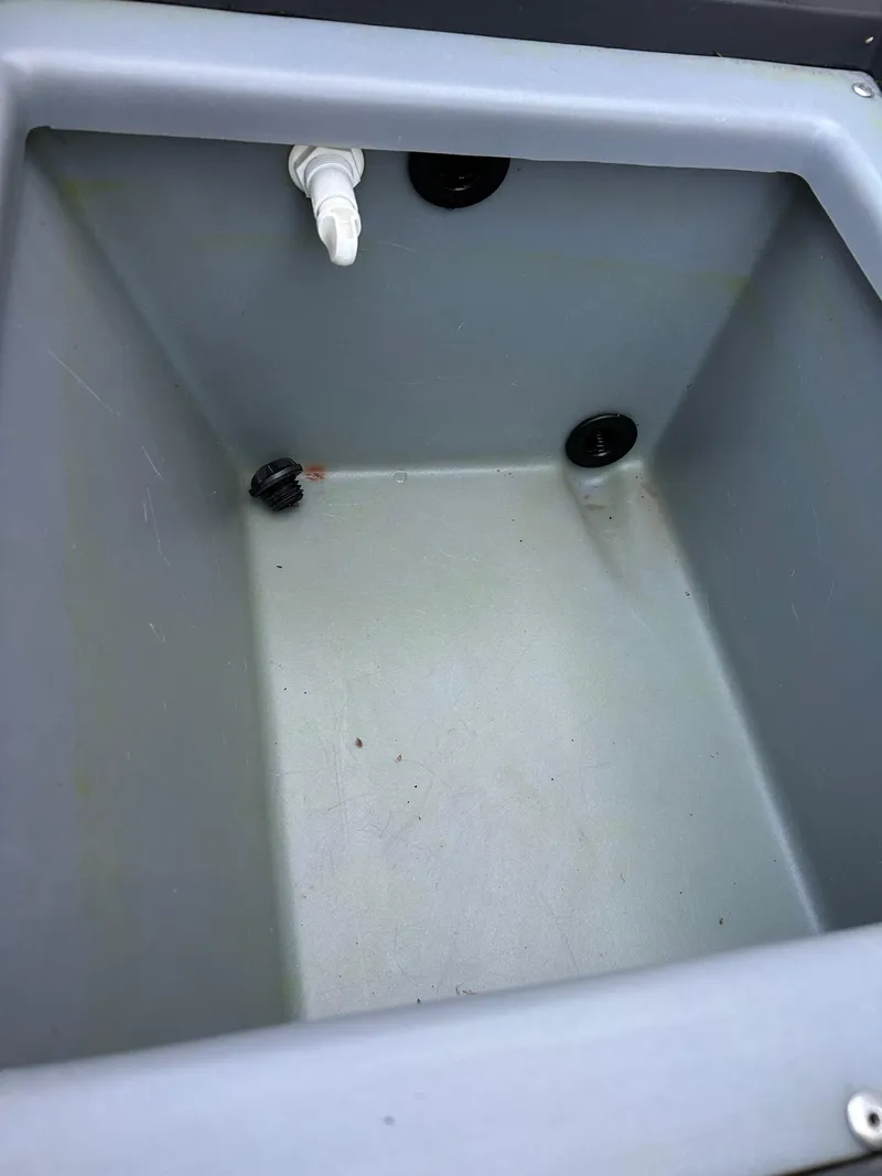 Slide: The Image of 2019 Tracker Pro 160 livewell interior with drain and fittings. - 25