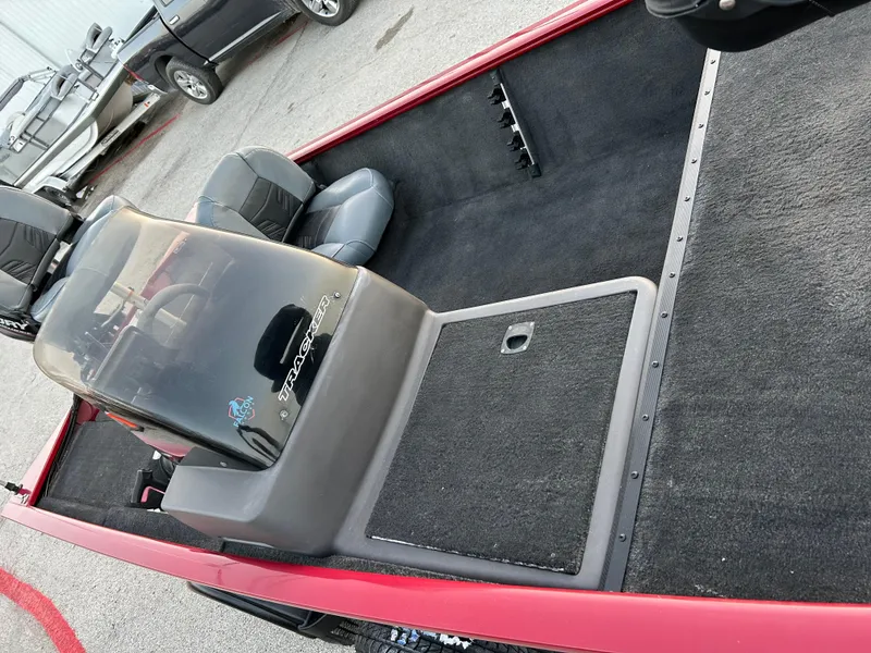 Slide: The Image of 2019 Tracker Pro 160 boat interior with seating and console, parked outdoors. - 39