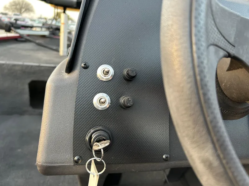Slide: The Image of Control panel of a 2019 Tracker Pro 160 boat with ignition key and switches. - 46