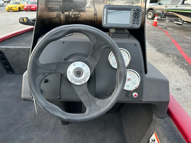 Slide: The Image of 2019 Tracker Pro 160 boat dashboard with steering wheel and gauges. - 47