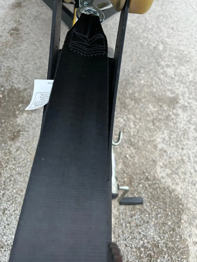 Slide: The Image of Close-up of a 2019 Tracker Pro 160 boat trailer strap mechanism. - 48
