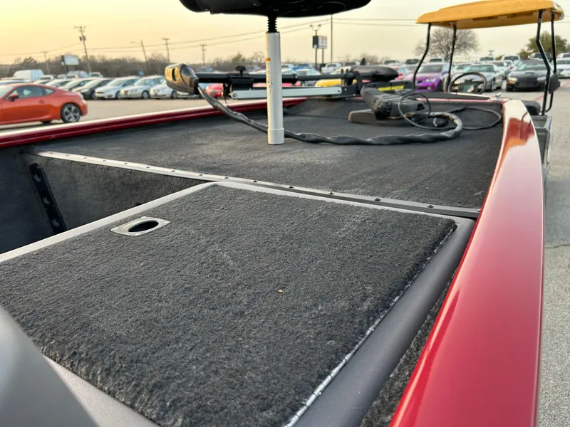 Slide: The Image of 2019 Tracker Pro 160 boat deck with fishing equipment in a parking lot. - 49