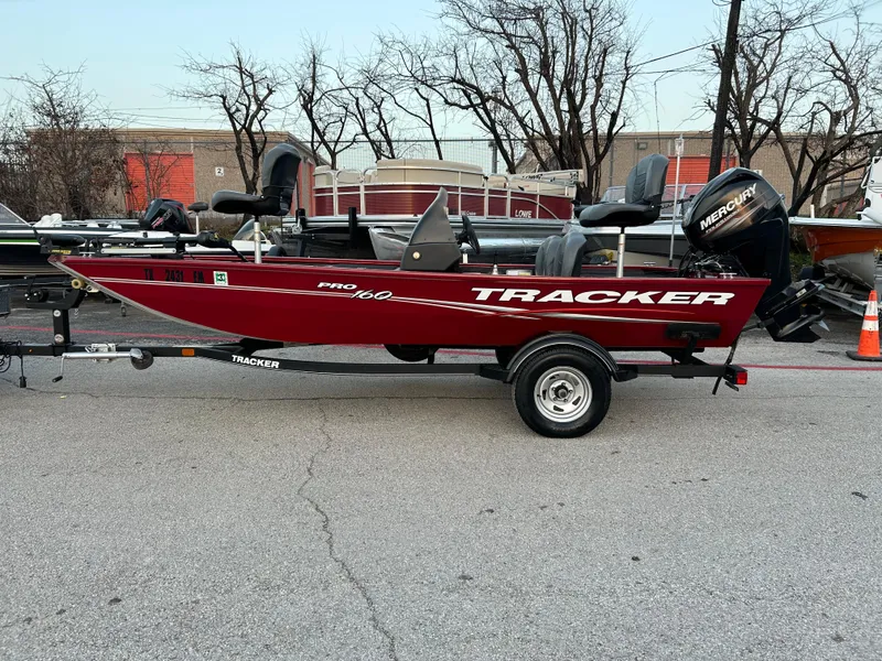 Slide: The Image of 2019 Tracker Pro 160 boat on trailer, red color, parked outdoors. - 5