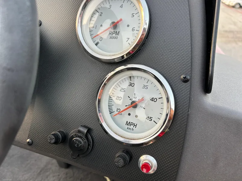 Slide: The Image of Dashboard of 2019 Tracker Pro 160 with RPM and MPH gauges. - 52