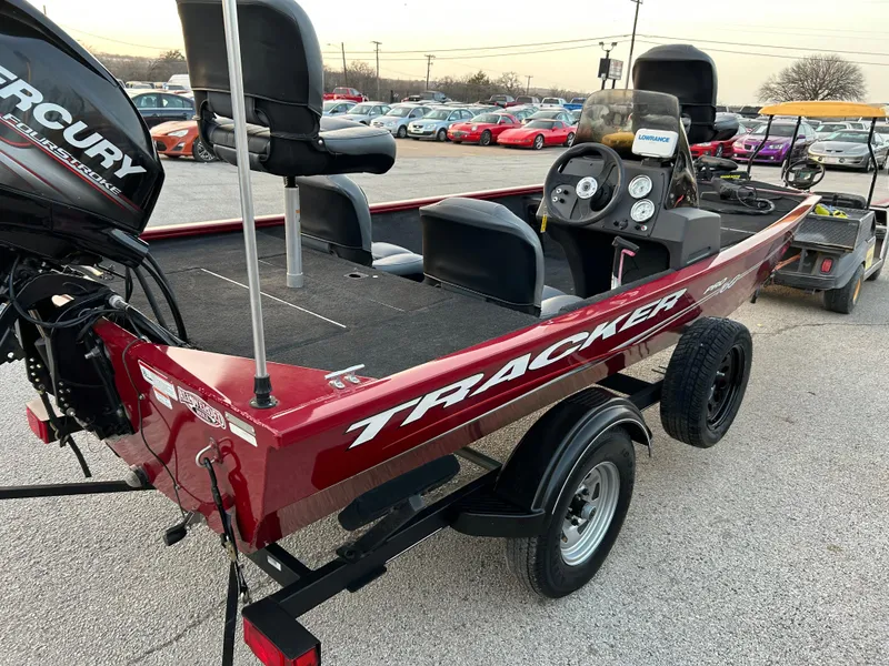Slide: The Image of 2019 Tracker Pro 160 boat on trailer in parking lot, featuring Mercury engine. - 7