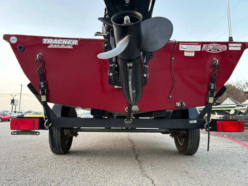 Slide: The Image of 2019 Tracker Pro 160 boat on trailer, rear view showing propeller and red hull. - 75
