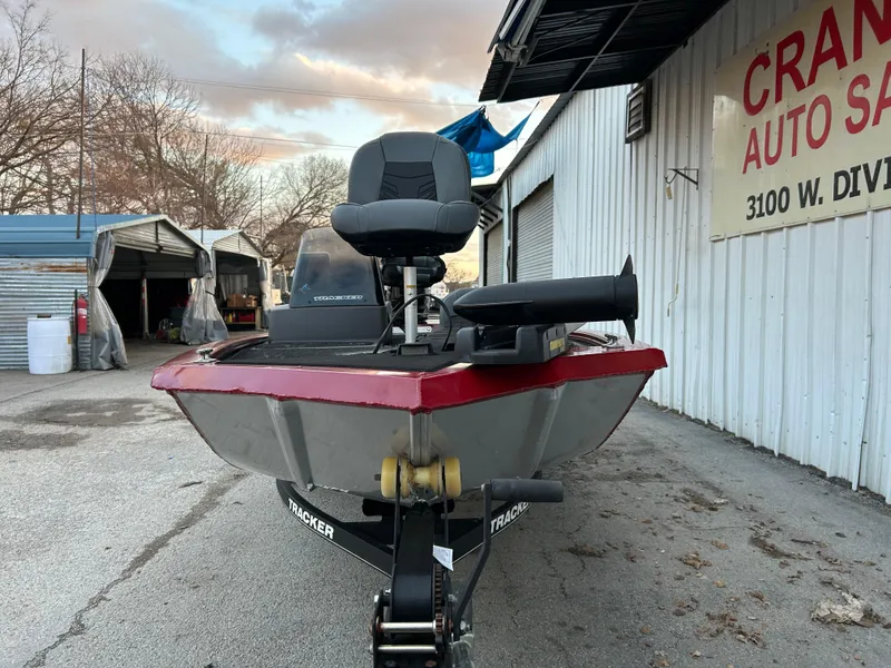 Slide: The Image of 2019 Tracker Pro 160 boat parked outside a garage. - 9