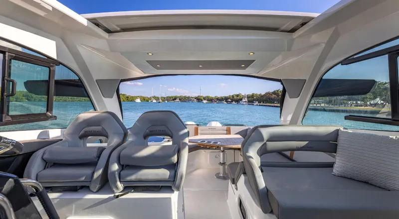 Slide: The Image of Interior view of 2021 Beneteau Gran Turismo 32 yacht with luxurious seating and scenic water view. - 10