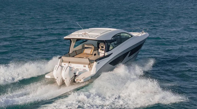 Slide: The Image of 2021 Beneteau Gran Turismo 32 cruising on open water, showcasing sleek design and powerful engines. - 3