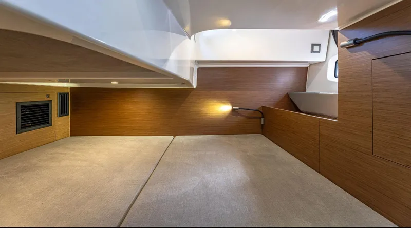 Slide: The Image of Interior cabin of 2021 Beneteau Gran Turismo 32, featuring modern wood paneling and cozy lighting. - 5