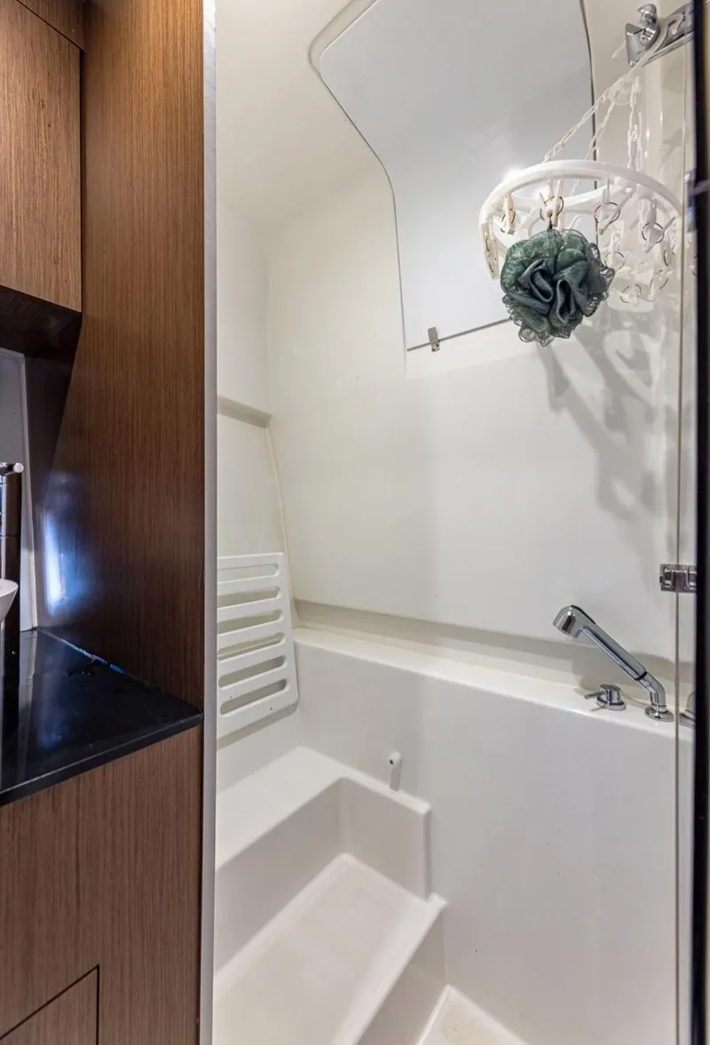 Slide: The Image of 2021 Beneteau Gran Turismo 32 yacht bathroom interior with modern fixtures and wooden accents. - 6