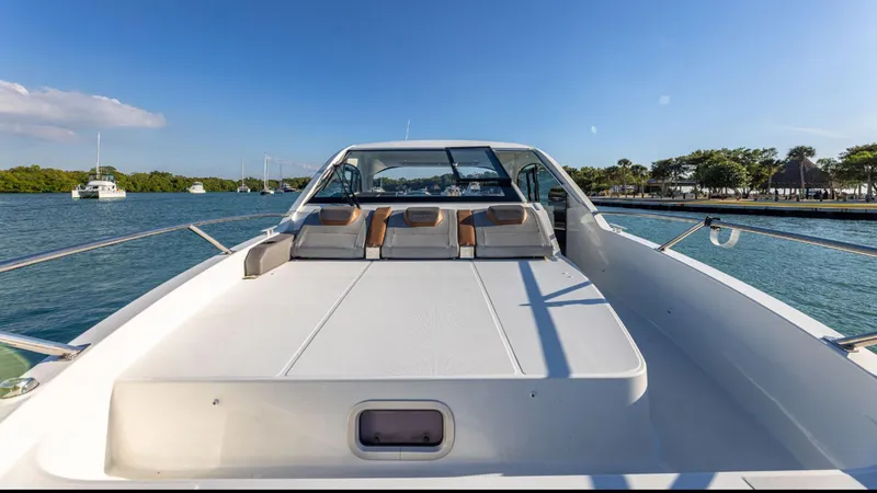 Slide: The Image of 2021 Beneteau Gran Turismo 32 yacht on calm water, showcasing sleek design and spacious deck. - 7