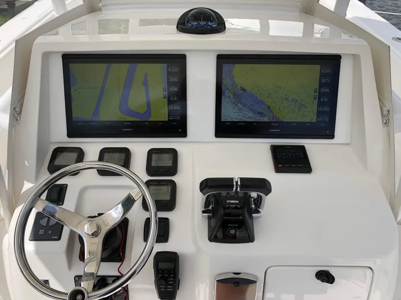 Slide: The Image of Control panel of a 2008 Intrepid 370 boat with navigation screens and steering wheel. - 11