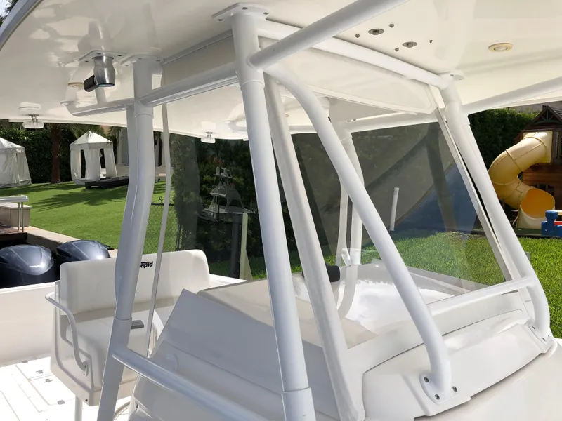Slide: The Image of 2008 Intrepid 370 boat with white frame and seating, displayed outdoors. - 15