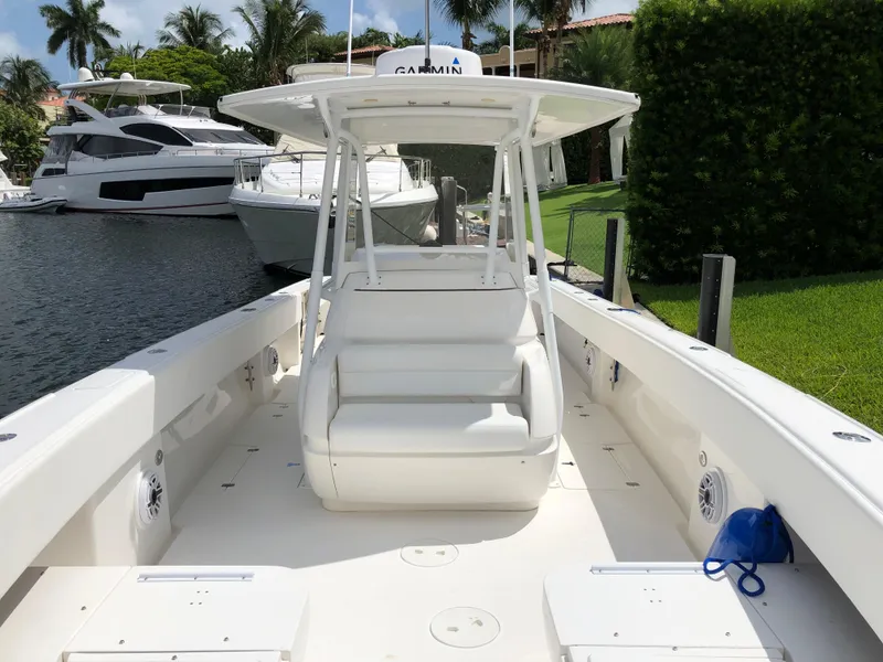 Slide: The Image of 2008 Intrepid 370 boat docked near luxury yachts, featuring spacious deck and modern design. - 16