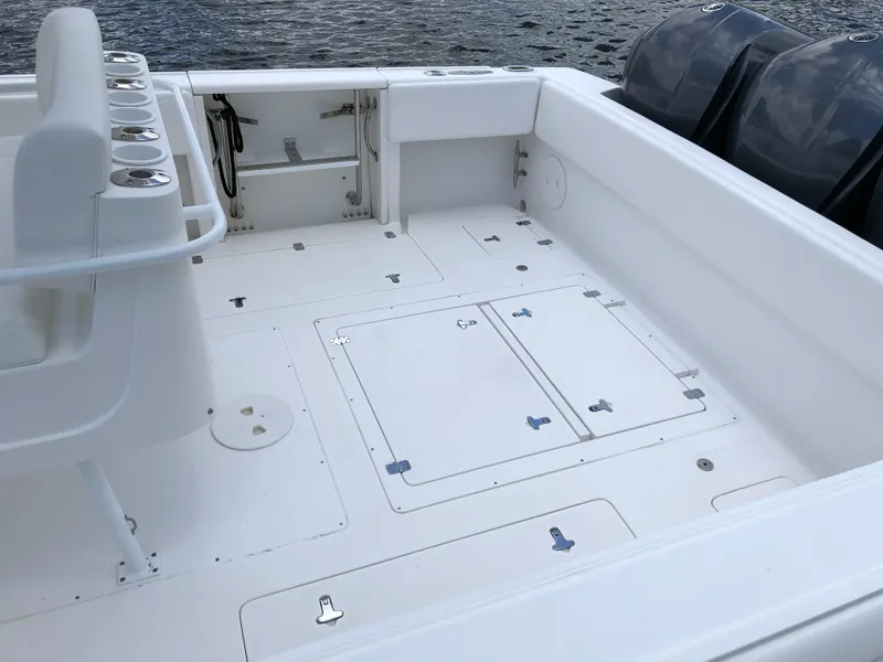 Slide: The Image of 2008 Intrepid 370 boat deck with storage compartments and dual engines. - 7