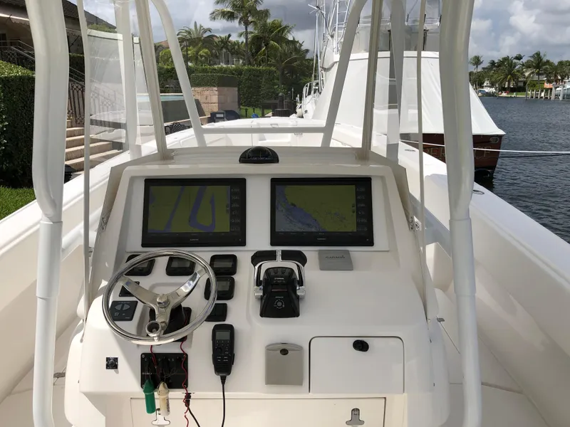 Slide: The Image of 2008 Intrepid 370 boat dashboard with navigation screens and steering wheel. - 9