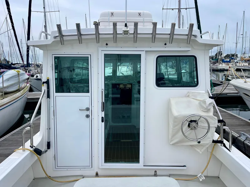 Slide: The Image of 2016 Farallon 3200 Explorer boat docked at marina, rear view showing cabin entrance. - 11