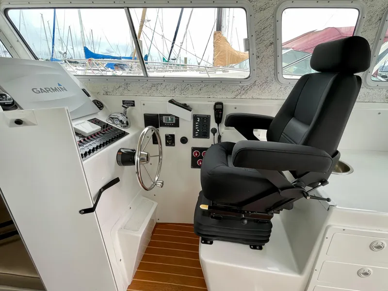 Slide: The Image of Interior of 2016 Farallon 3200 Explorer boat with steering wheel and captain's chair. - 13