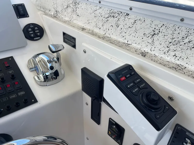 Slide: The Image of Control panel of 2016 Farallon 3200 Explorer boat with throttle and navigation controls. - 16