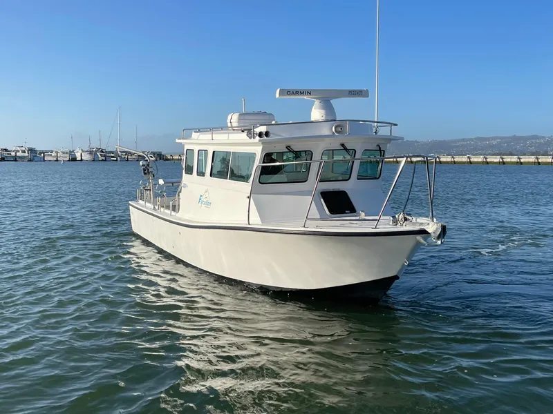 Slide: The Image of 2016 Farallon 3200 Explorer boat on calm water, clear sky background. - 2