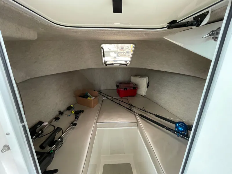 Slide: The Image of 2016 Farallon 3200 Explorer cabin interior with fishing rods and gear. - 20