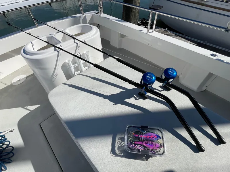 Slide: The Image of Fishing rods on a 2016 Farallon 3200 Explorer boat deck, with tackle box nearby. - 28