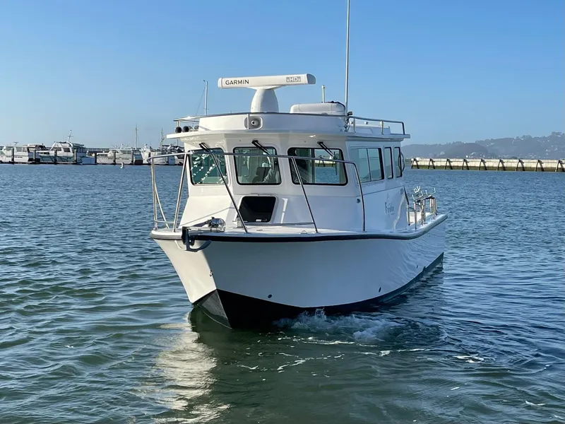 Slide: The Image of 2016 Farallon 3200 Explorer boat cruising on calm water near a marina. - 3
