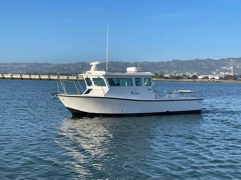 Slide: The Image of 2016 Farallon 3200 Explorer boat on calm water with scenic background. - 4