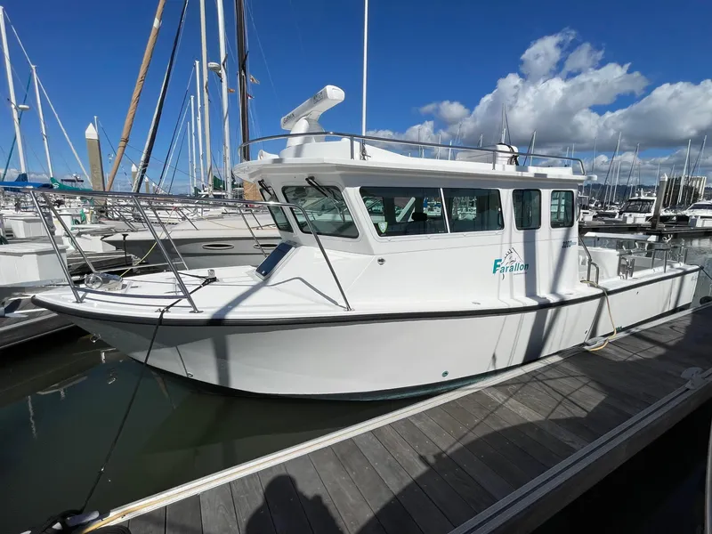 Slide: The Image of 2016 Farallon 3200 Explorer boat docked at marina under blue sky. - 5