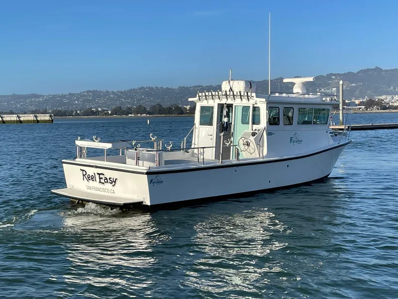 Slide: The Image of 2016 Farallon 3200 Explorer boat cruising on calm waters. - 6