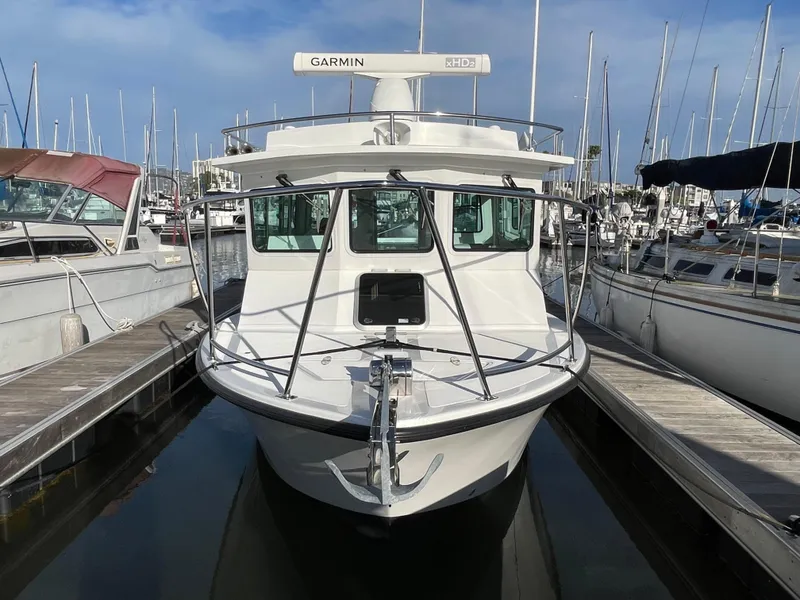 Slide: The Image of 2016 Farallon 3200 Explorer boat docked at marina, front view. - 8
