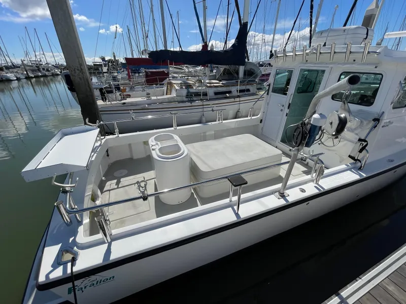Slide: The Image of 2016 Farallon 3200 Explorer boat docked in marina, featuring spacious deck and fishing equipment. - 9