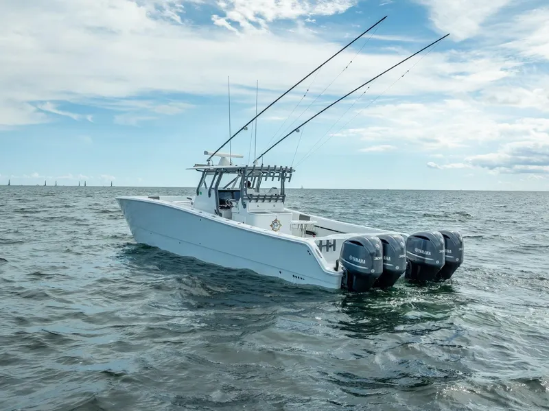 Slide: The Image of Freeman 42 boat, 2017 model, with fishing rods and twin engines on open water. - 11