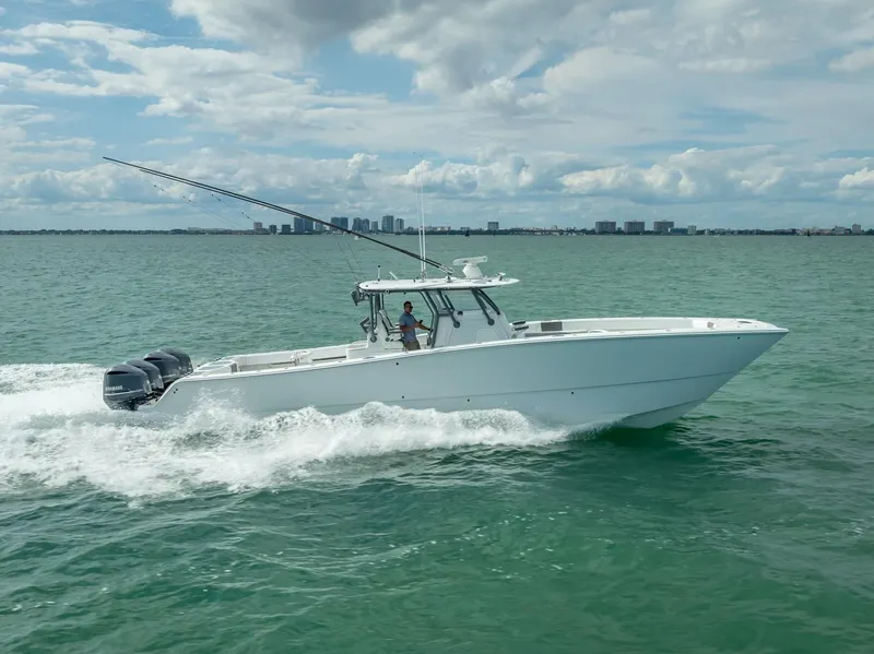 Slide: The Image of 2017 Freeman 42 boat cruising on open water under cloudy sky. - 15