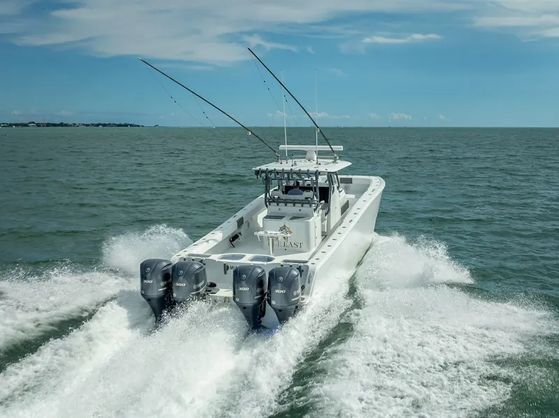 Slide: The Image of Freeman 42 boat cruising on open water, 2017 model, with multiple outboard engines. - 16