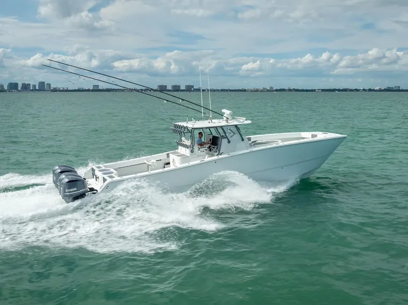 Slide: The Image of 2017 Freeman 42 boat cruising on open water with city skyline in background. - 17