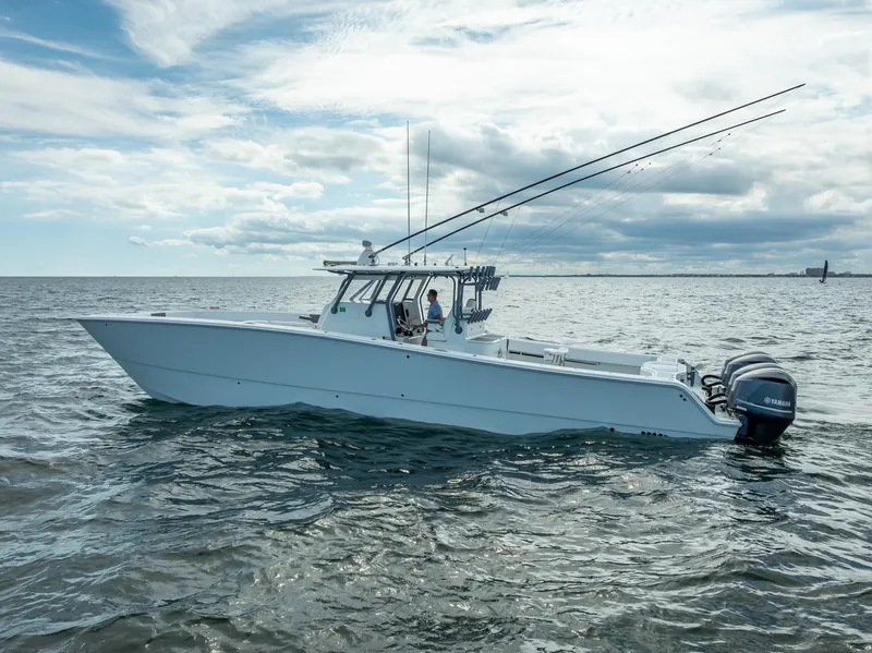Slide: The Image of 2017 Freeman 42 boat on open water with fishing rods and Yamaha engines. - 3