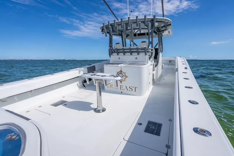 Slide: The Image of 2017 Freeman 42 boat on open water, clear sky, spacious deck, luxury fishing vessel. - 34