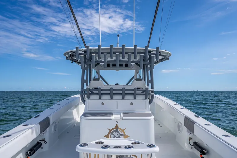 Slide: The Image of Freeman 42 boat, 2017 model, on open water under a clear blue sky. - 35