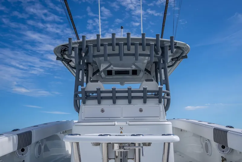 Slide: The Image of 2017 Freeman 42 boat with rod holders against a clear blue sky. - 37