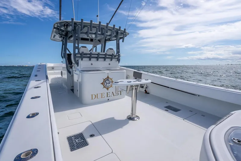 Slide: The Image of 2017 Freeman 42 boat on open water, featuring spacious deck and fishing equipment. - 38