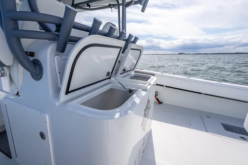 Slide: The Image of 2017 Freeman 42 boat with open storage compartments on deck, overlooking the ocean. - 39
