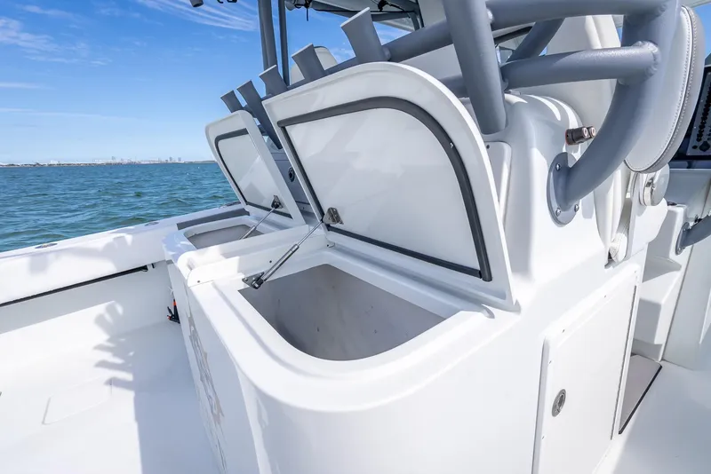 Slide: The Image of Open storage compartments on a 2017 Freeman 42 boat, with ocean view in the background. - 40