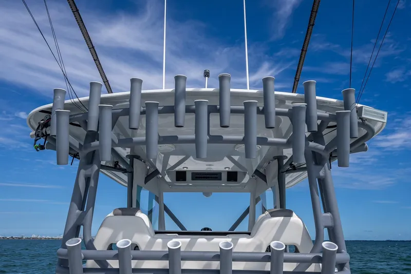 Slide: The Image of Freeman 42 boat, 2017 model, featuring multiple rod holders against a clear blue sky. - 42