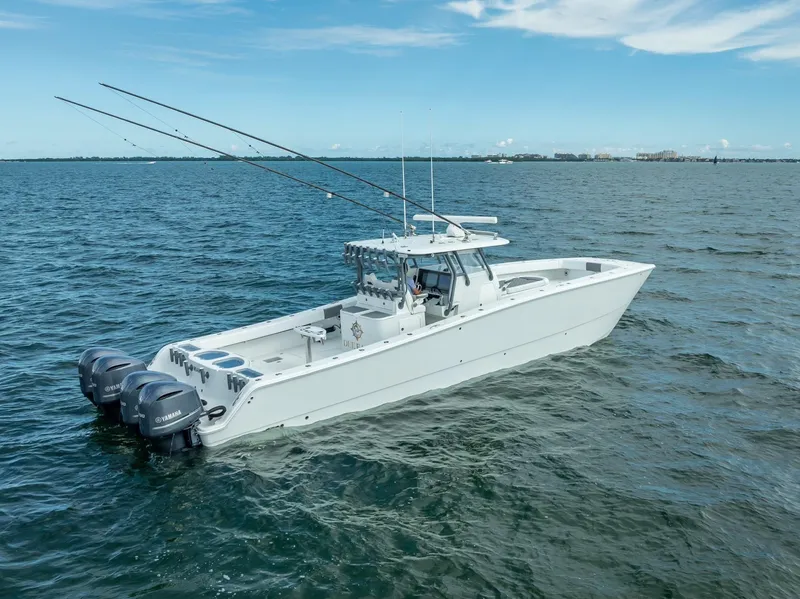 Slide: The Image of 2017 Freeman 42 boat on open water, equipped with dual outboard motors. - 7