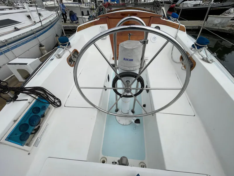 Slide: The Image of 1984 Catalina 30 sailboat cockpit with steering wheel and navigation instruments. - 3